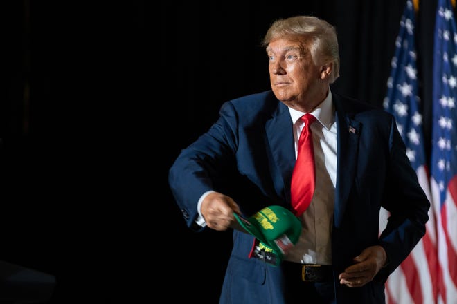 Former President Donald Trump tosses a Farmers for Trump hat into the crowd before speaking, on Friday, July 7, 2023, at the Mid-America Center, in Council Bluffs.