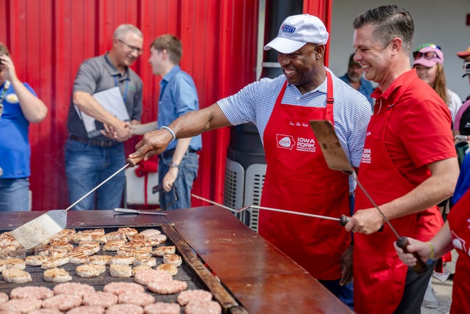 Sen. Tim Scott, R-S.C., left, works the grill outside the Iowa Pork Producers tent with Rep. Zach Nunn, R-Iowa at the Iowa State Fair, Tuesday, Aug. 15, 2023.