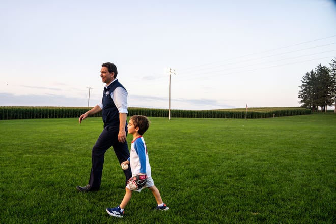 Gov. Ron DeSantis walks out to the edge of the cornfield with his son Mason at the Field of Dreams movie site on Thursday, August 24, 2023 in Dyersville.