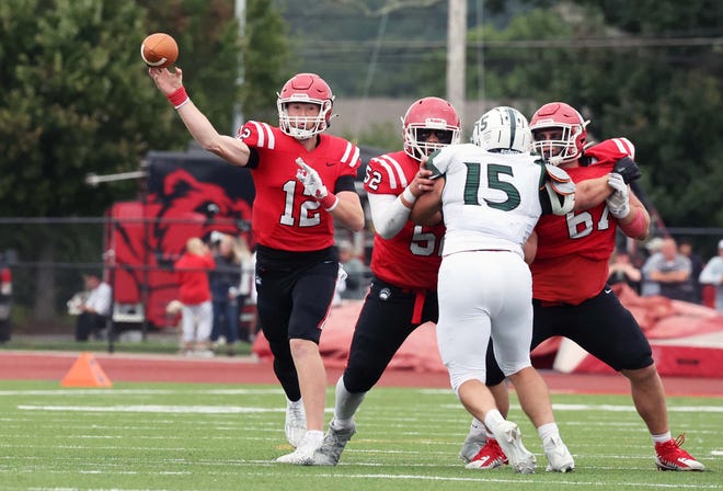 Bridgewater State University quarterback James Cahoon completes a third quarter pass as linemen from left, Anton Vasquez Matt Beyer block Plymouth State University pass rusher Alex Flynn during a game on Saturday , Sept. 16, 2023.