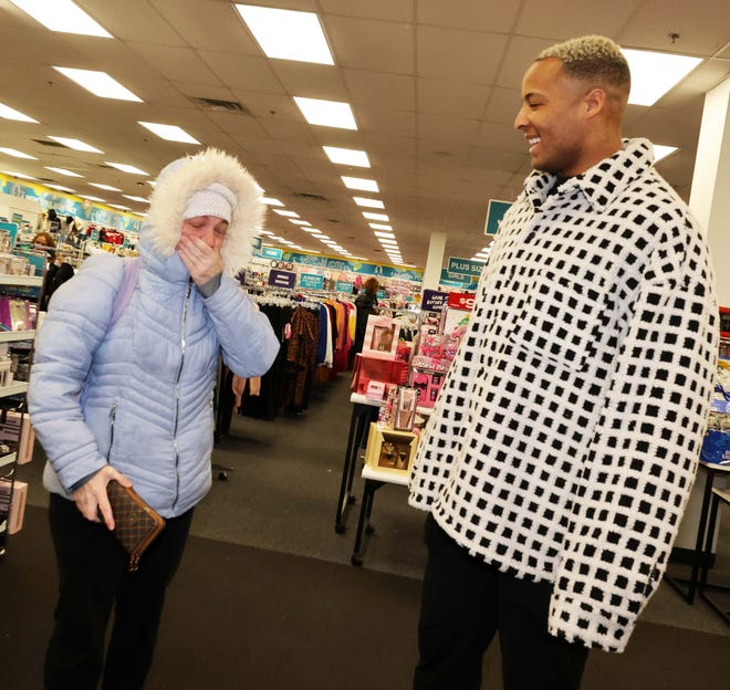 Customer Nicole Miller with New England Patriots tight end Pharaoh Brown at a surprise holiday payoff event at Brockton Citi Trends on Tuesday, Dec. 12, 2023. Customers had their layaway items paid off from a partnership between the nonprofit Pay Away and Brown.