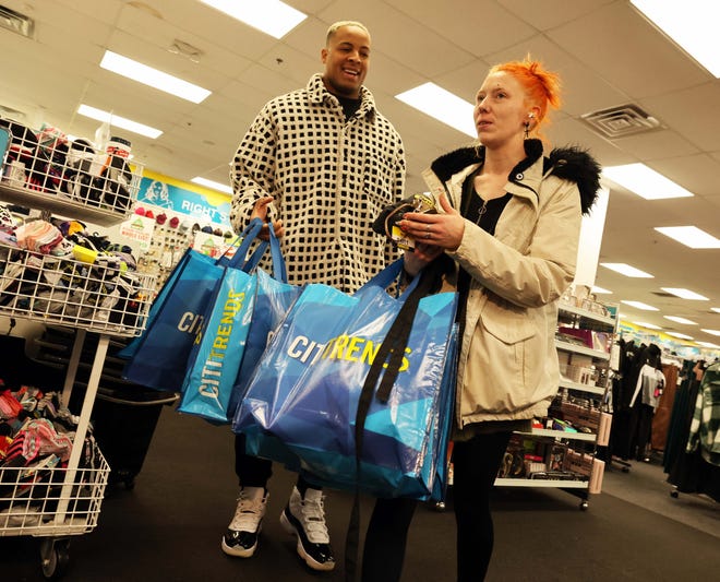 Customer Brittany Zappi with New England Patriots tight end Pharaoh Brown at a surprise holiday payoff event at Brockton Citi Trends on Tuesday, Dec. 12, 2023. Customers had their layaway items paid off from a partnership between the nonprofit Pay Away and Brown.