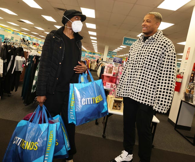 Customer Shayla Littleton thanks New England Patriots tight end Pharaoh Brown at a surprise holiday payoff event at Brockton Citi Trends on Tuesday, Dec. 12, 2023. Customers had their layaway items paid off from a partnership between the nonprofit Pay Away and Brown.