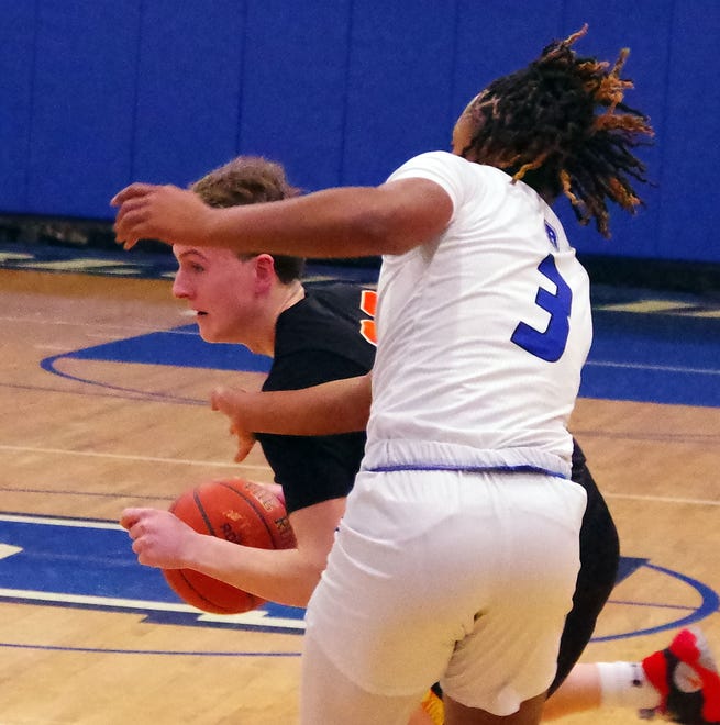 Co-captain Matt Youngquist of Middleboro tries to go around Randolph defender #3 Jordan Nash in first half basketball action on Friday, Dec. 15, 2023.