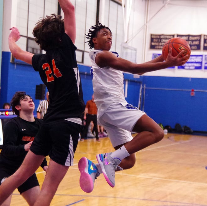 Randolph consistently attacked the basket in transition in the 2nd half, as Daren Nash of the Blue Devils goes for the score against Middleboro's Jackson Davenport on Friday, Dec. 15, 2023.