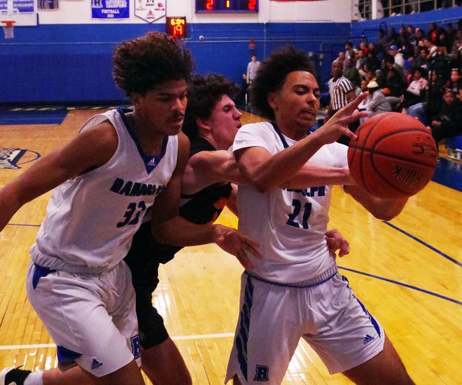 Edgar Furtado of Randolph (L), Brady Roche of Middleboro, and Jonathan Rivera of Randolph, battle for a loose ball in the 1st half of a tight basketball game on Friday, Dec. 15, 2023.