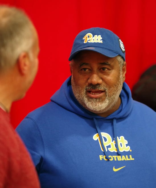 Jose Monteiro, the father of Cameron Monteiro, who just committed to attend the University of Pittsburgh to play football, talks with Brockton Athletic Director Kevin Karo after the signing ceremony on Wednesday, Dec. 20, 2023.