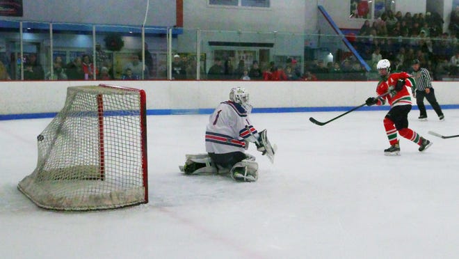 The first period of the hockey game between Rockland and Abington sees the Green Wave's Hunter Grafton strikes first blood on Bulldog goalie Rickey Esancy on Tuesday, Dec. 26, 2023.