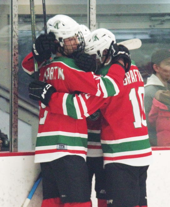 Abington's Evan St. Martin gets embraced by teammates after scoring the Green Wave's 3rd goal in the third period against Rockland on Tuesday, Dec. 26, 2023.