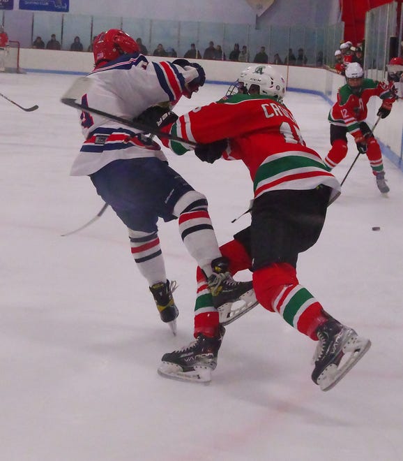 #4 Jack Blonde of Rockland and #15 Cullen Crocker of Abington come together for a hard hit in the 3rd period of their game on Tuesday, Dec. 26, 2023.