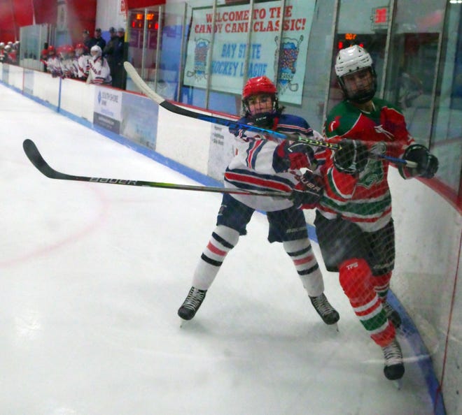 Dean Alex of Rockland looks to slow the momentum of Evan St. Martin of Abington as Alex tries to protect his goal during the game on Tuesday, Dec. 26, 2023.