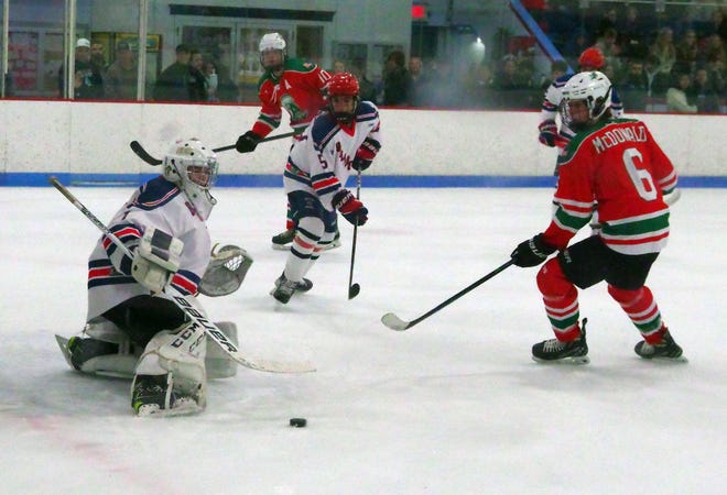 Rockland's goalie Ricky Esancy manages to kick save a shot on goal by Abington's Sam McDonald during the game on Tuesday, Dec. 26, 2023.