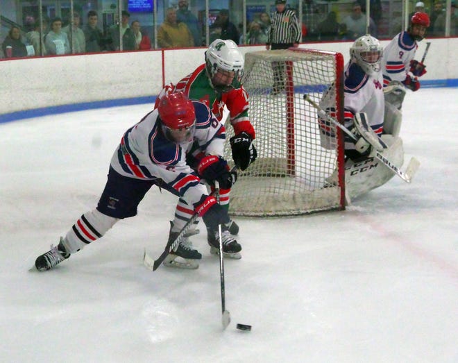 Joey Mann of Rockland battles Abington's Colin McDermott for control of the puck as Mann tries to grab it and clear it out of the Bulldogs' zone on Tuesday, Dec. 26, 2023.