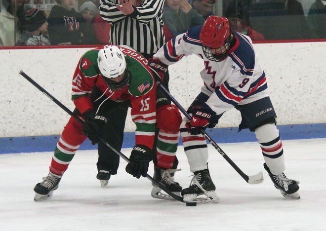 Abington's Cullin Crocker tries to get control of the puck from Rockland's Cooper Larouco of Rockland in first-period action on Tuesday, Dec. 26, 2023.