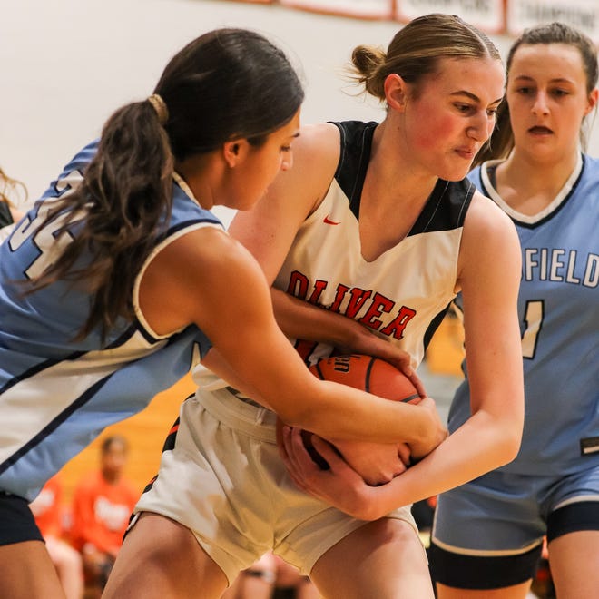 Oliver Ames' Sarah Hilliard battles Medfield's Naya Annigeri for the ball during a game at Oliver Ames High School on Friday, Dec. 29, 2023.