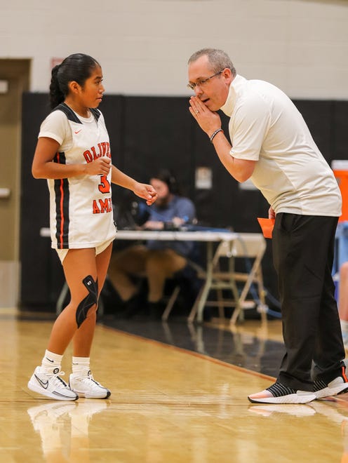 Oliver Ames' girls basketball coach Brian Costello gives instruction to Mari Rhodes during a game against Medfield at Oliver Ames High School on Friday, Dec. 29, 2023.