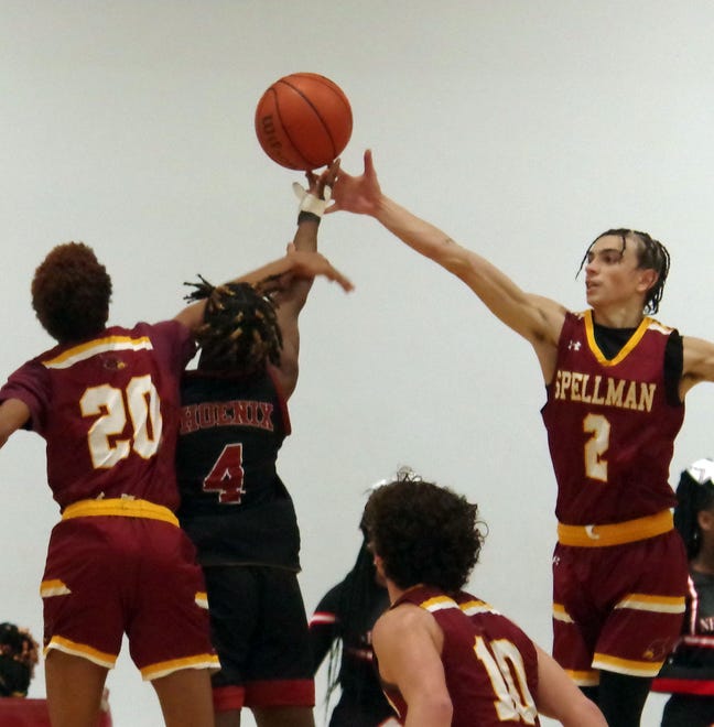 Elijah Goncalves (#20, L) and Isaiah Goodridge (#2, R) of Cardinal Spellman try to prevent Marvins Leplante #4 of New Heights of putting up a layup in the 2nd half of the basketball game on Wednesday, Jan. 3, 2024.