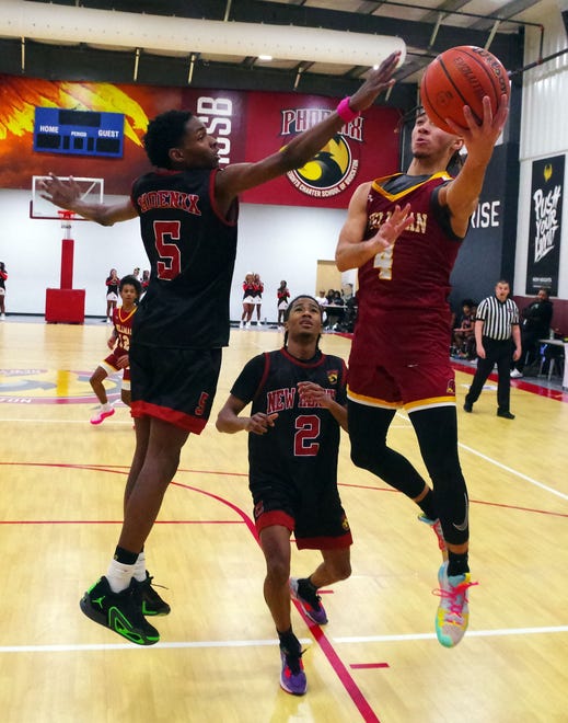 #5 of New Heights Ray Miller tries to block a shot by Cardinal Spellman's D'Anthony Amado in the 2nd half of the game on Wednesday, Jan. 3, 2024.